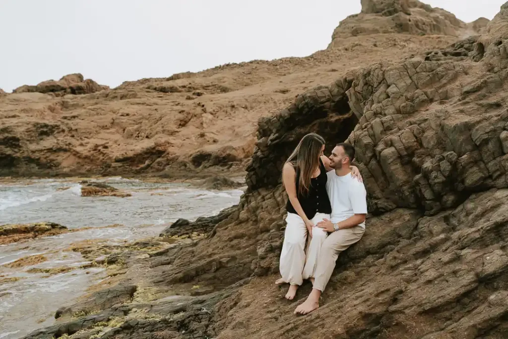 Marta y Álvaro sentados sobre las rocas en Cabo de Gata