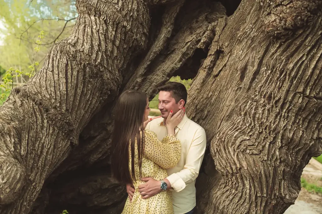 Rocío e Iván junto a un gran árbol durante su sesión de pareja en Granada